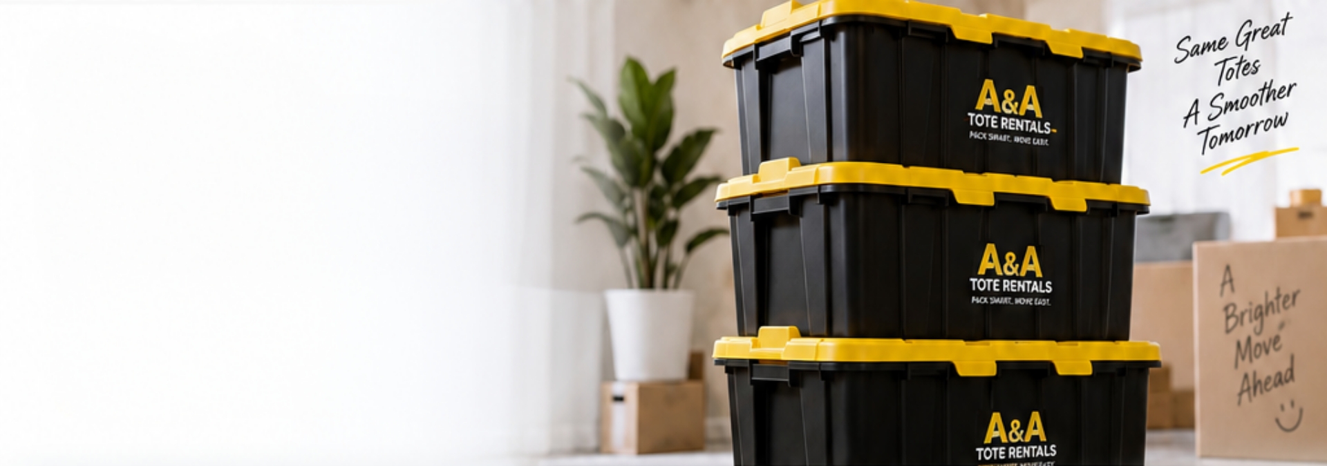 A stack of three black A&A Tote Rentals totes with yellow lids in a bright room ready for a move